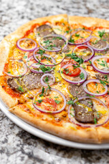 pizza with meat, onion and cheese