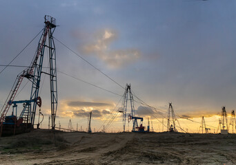 Oil production in the vicinity of Baku. Azerbaijan. Sunset. Evening. Oil fields.