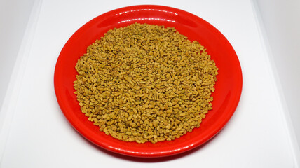 The pile of Fenugreek red plate is on a white background