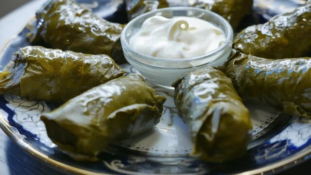 Delicious dolma with the cream sauce on a asian plate