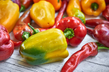 Colorful peppers on the wooden background. Copy space.