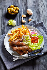 cevapcici with potato fries, lettuce, onion, ajvar