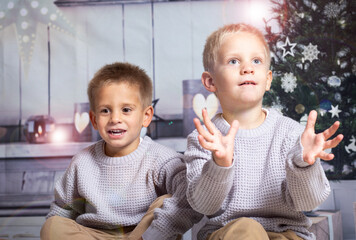 Twin boys at home at christmas parties