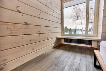 Room interior in a country house with parquet and natural wood walls