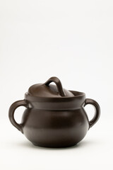 Brown ceramic pot on white background