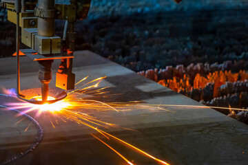 Gas cutting of sheet steel on a machine with numerical control. Splashes of molten metal.