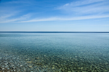 Fototapeta premium Crystal clear water with ripples and pebbles in Lake Huron, from Mackinac Island, Michigan
