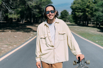 Portrait of young boy with sunglasses and a skateboard