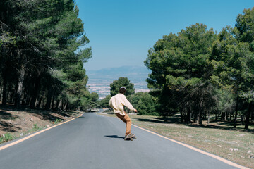 Hipster boy riding a skateboard in the street