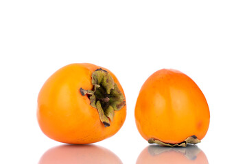 Two ripe sweet persimmons, close-up, isolated on white.