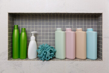 jars and bottles with cosmetic products on a shelf in the bathroom