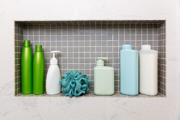 jars and bottles with cosmetic products on a shelf in the bathroom