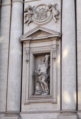 Fototapeta na wymiar Sant'Andrea della Valle Church Facade Detail with Statue of Saint Sebastian and Columns in Rome, Italy