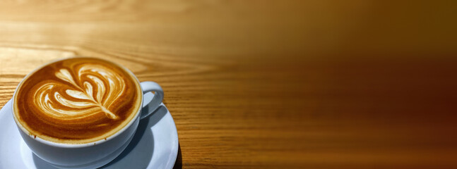 Hot art Latte Coffee in a cup on wooden table.