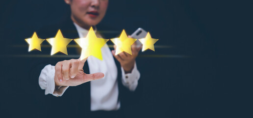 The concept of placing rating. woman touching technology on five star excellent rating on blue...