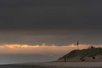 Obraz premium Beautiful sunrise landscape image of Talacre beach at surnise with dramatic sky and clouds