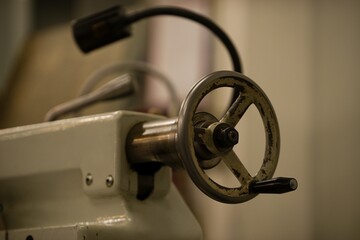 Old metal lathe machine, retro machine background.
