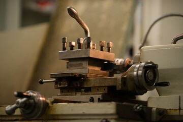 Old metal lathe machine, retro machine background.