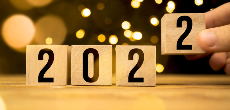 2022 on wooden blocks. Concept of changing the new year. Christmas bokeh background photo