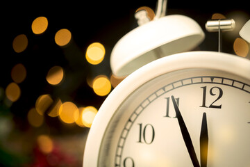 Five minutes to midnight. Midnight countdown to new year. Bokeh and sparks on dark background, new year's eve concept