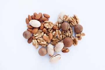 Heart of various several types of nuts-macadamia, almonds, walnuts, pecans on a white background