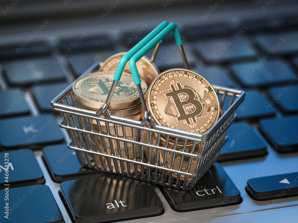 Poster bitcoin coins in shopping basket on laptop keyboard. bitcoin wallet and payment.