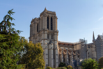 Cityscape view of the exterior stone architecture of the famous Notre Dame de Paris, including...