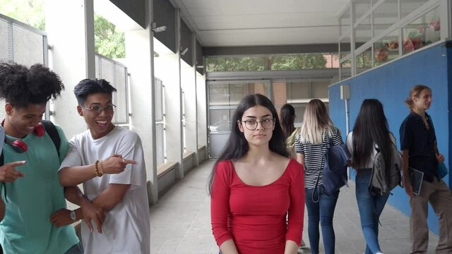 Teenage multi-ethnic students bully a girl in high school.