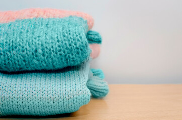 clean sweaters after washing,stacks of clean knitted clothes. Concept of cozy home and house work. Cope space.