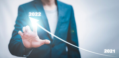 Business growth data chart arrow with diagram 2022 budget, Businessman pointing arrow graph corporate future growth year 2021 to 2022, Development to success and motivation.
