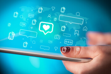 Close-up of a hand using tablet, social media concept