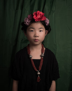 Fine art studio portrait of asian girl in Frida Kahlo style