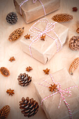 christmas gifts with fir cones top view. Christmas gifts on a wooden background. gifts packed by hand. Handmade work.