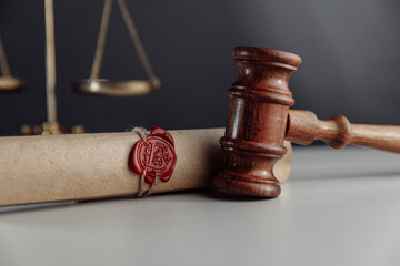 Gavel and document with wax seal on a lawyer's desk close-up
