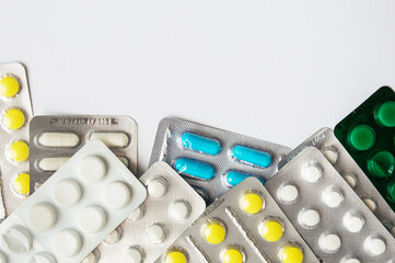 Medical mercury thermometer on the background of pills and a protective mask. Coronavirus and isolation. Medicinal medicine as background.
