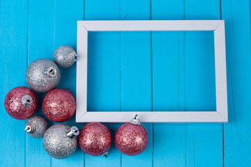 Frame and Christmas decor on a blue background.