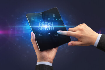 Businessman holding a foldable smartphone, security concept