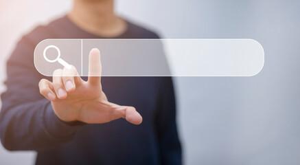 Businessman clicking internet search page on a computer touch screen or blank search bar,  internet and technology concept, Analysis the Internet to connect wirelessly, search engine optimization.