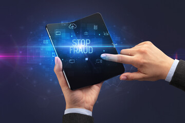 Businessman holding a foldable smartphone, security concept