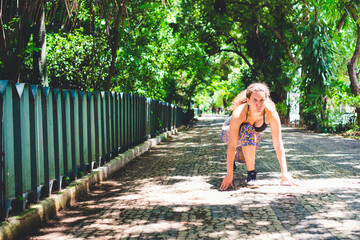 Woman running outdoors. Caucasian woman in gym clothes doing jogging in park. Outdoor activities. Photo with space for text.
