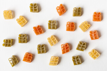 Gifts pattern made of raw wheat pasta on a white background. Flat lay, top view. Concept of sale, surprise, present, black friday.