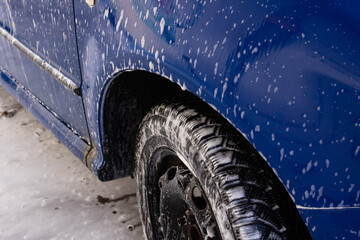 Blue car in foam at a car wash