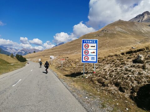 mtb riders on a road at col de larche