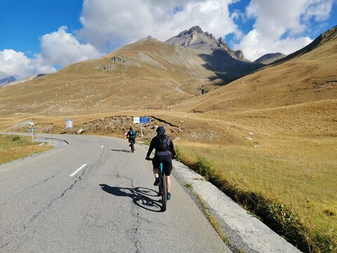 mtb riders on a road at col de larche