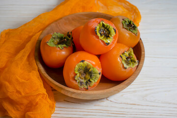 persimmon fruit on wooden background
