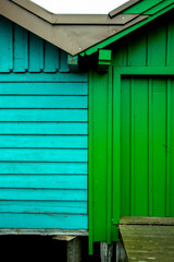 Fototapeta na wymiar Dos casas de madera adosadas con colores analogos 
