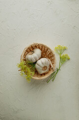Various spices and herbs in a bowl on wooden background. Asian food ingredients. Natural spices and garlic. Top view.