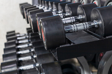 storage of dumbbells in the gym. rows of dumbbells