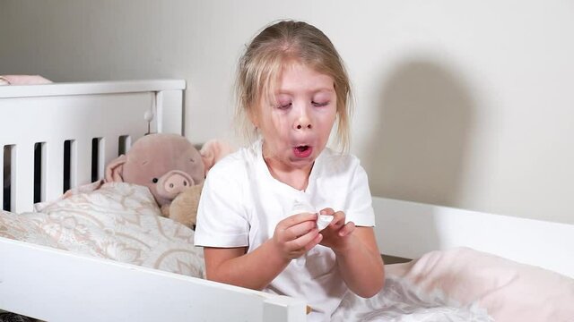 The child blows his nose into a handkerchief and wipes off the snot. Childhood diseases: runny nose, sinusitis, renitis, allergies. An independent girl knows how to wipe snot herself. The girl is sick