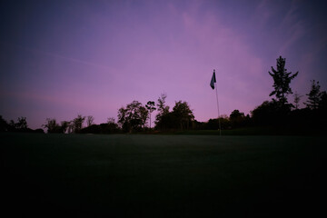 night photography of a green as dawn begins